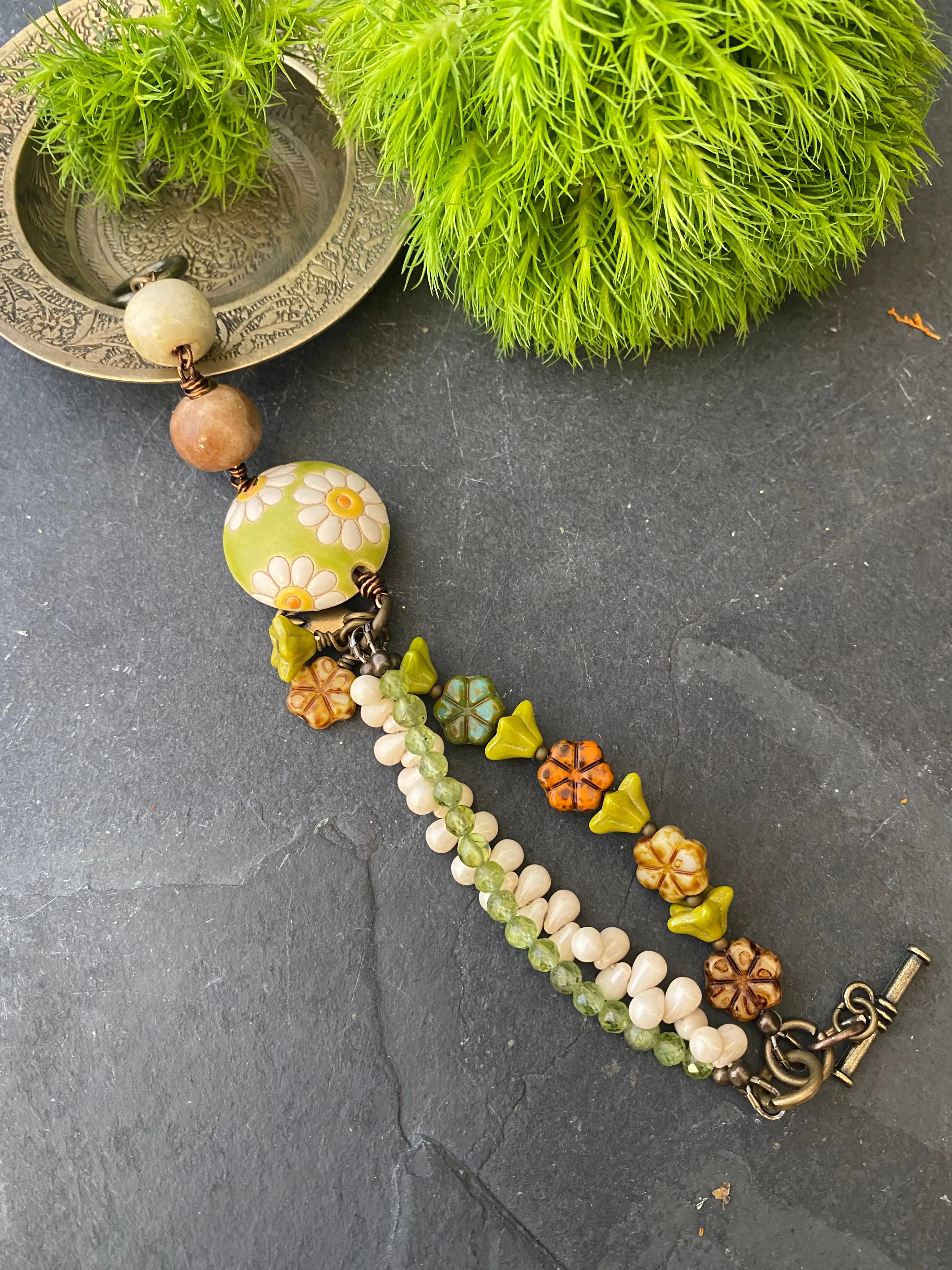 Daisies. Peridot stone, Czech glass flowers, ceramic beads, brinze metal, multi strand, bracelet