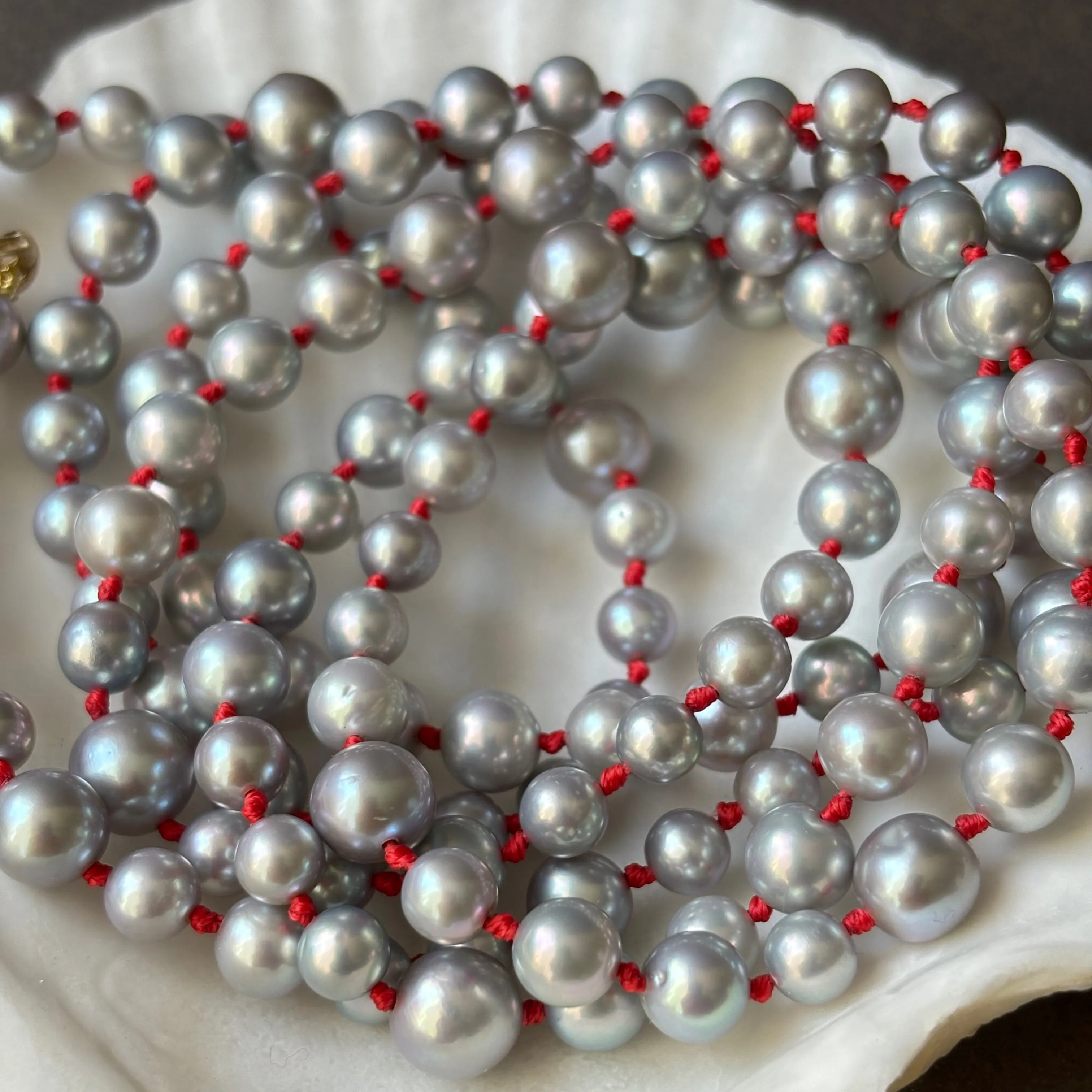 rope of silver pearls on lucky red knots