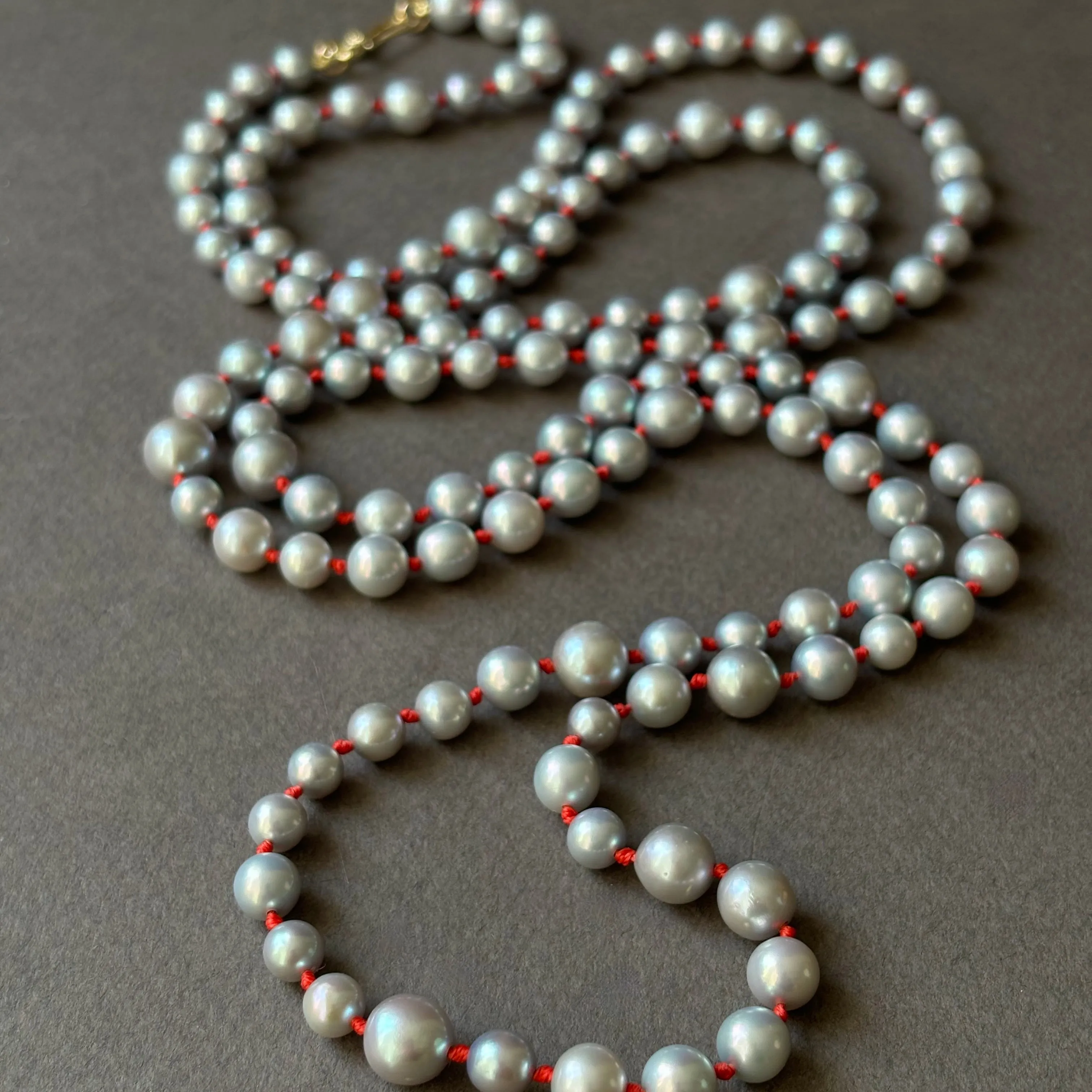 rope of silver pearls on lucky red knots